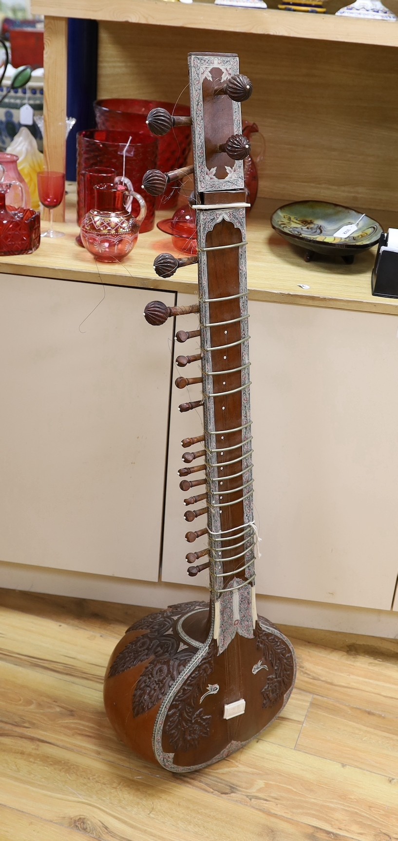 A sitar with wooden carved decoration